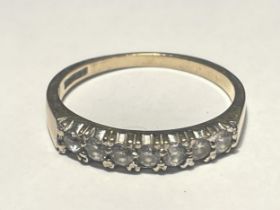 A 9 CARAT GOLD RING WITH SEVEN IN LINE CUBIC ZIRCONIAS SIZE Q/R