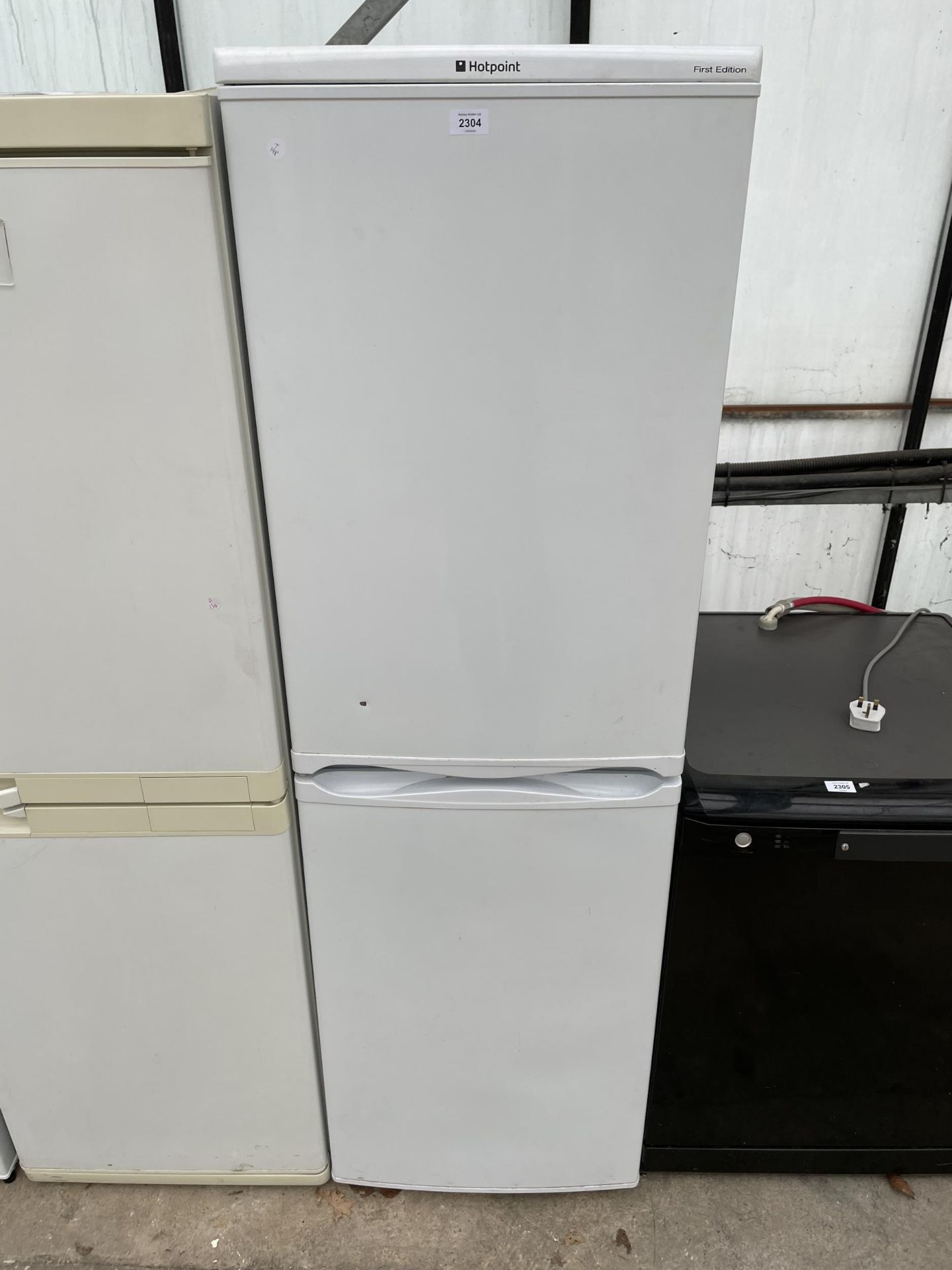 A TALL WHITE HOTPOINT UPRIGHT FRIDGE FREEZER