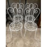 A SET OF FOUR ORNATE AND DECORATIVE WROUGHT IRON BISTRO CHAIRS