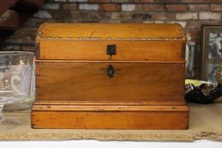 A LARGE WOODEN CHEST WITH STUDDED DETAIL
