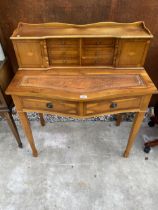 A YEW WOOD LADIES WRITING TABLE ENCLOSING CUPBOARDS AND DRAWERS ON TAPERING LEGS 35" WIDE