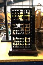 A LARGE VINTAGE WOODEN ABACUS WITH TWO SIDES OF BEADS, HEIGHT APPROX 42CM