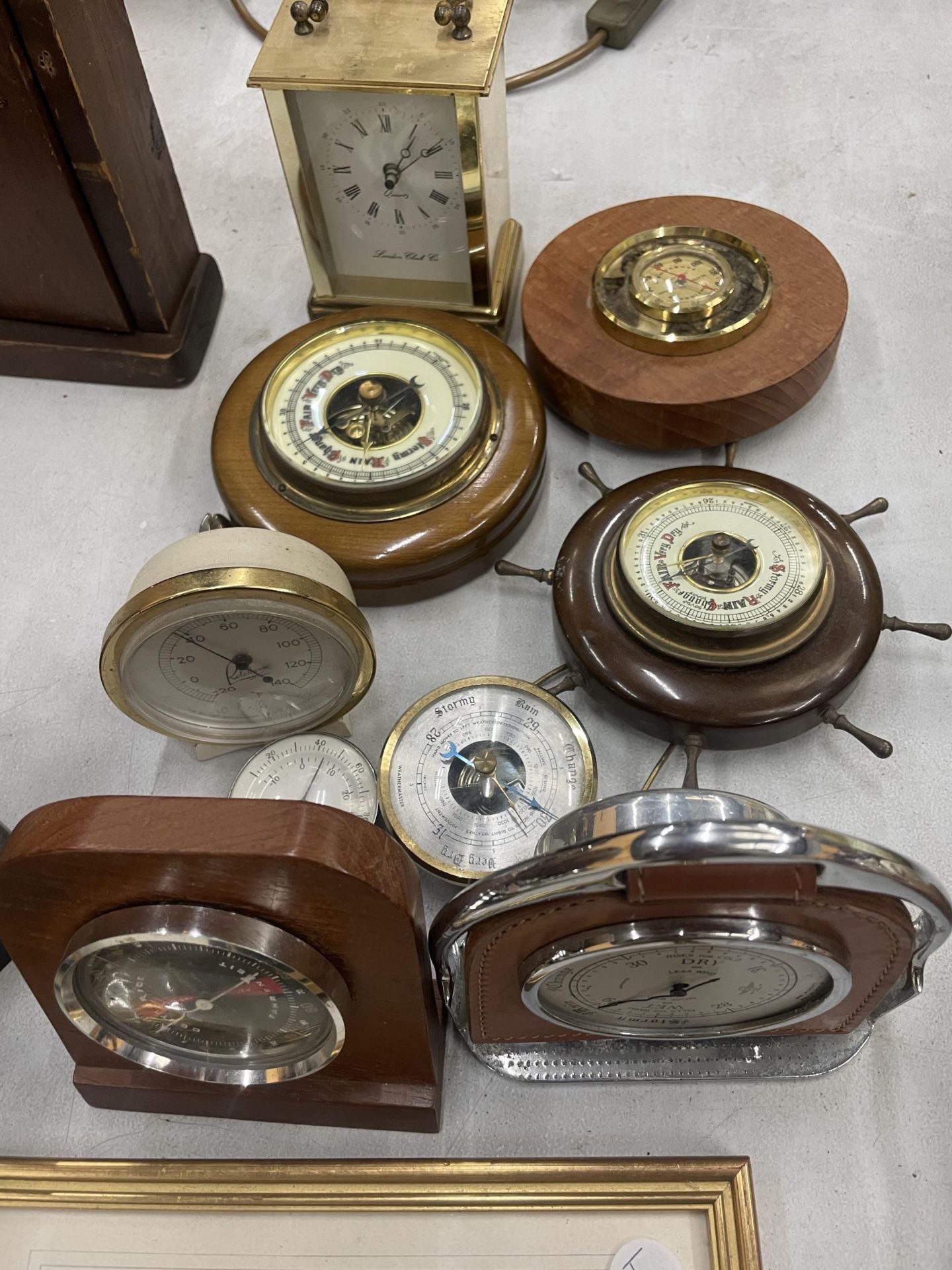 A COLLECTION OF SMALL BAROMETERS PLUS A BRASS CARRIAGE CLOCK