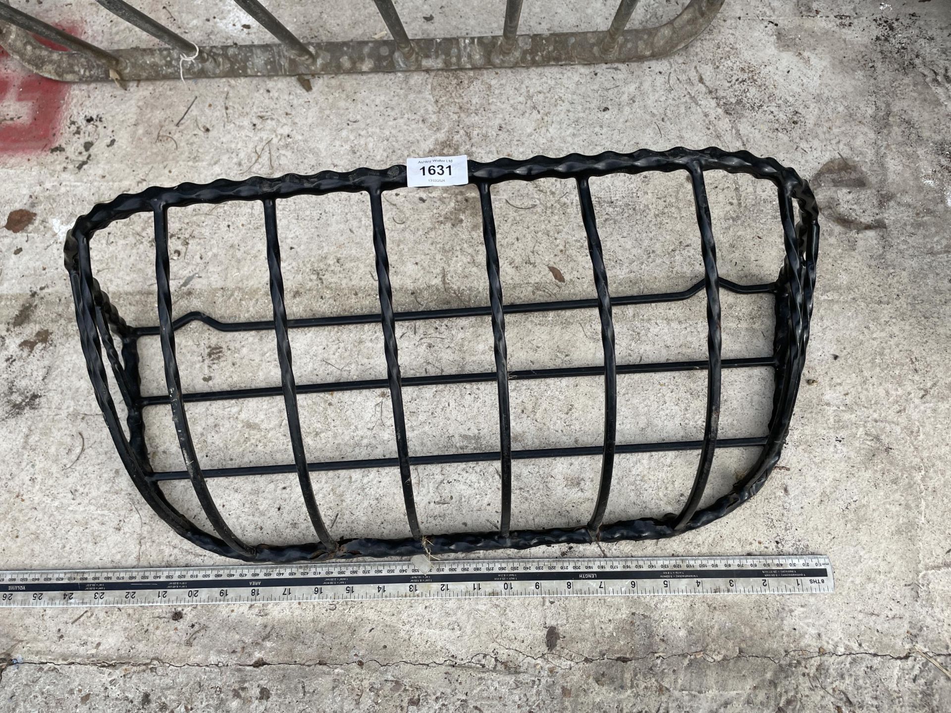 A METAL WALL HANGING HAYRACK PLANTER