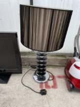 A DECORATIVE TABLE LAMP WITH SHADE