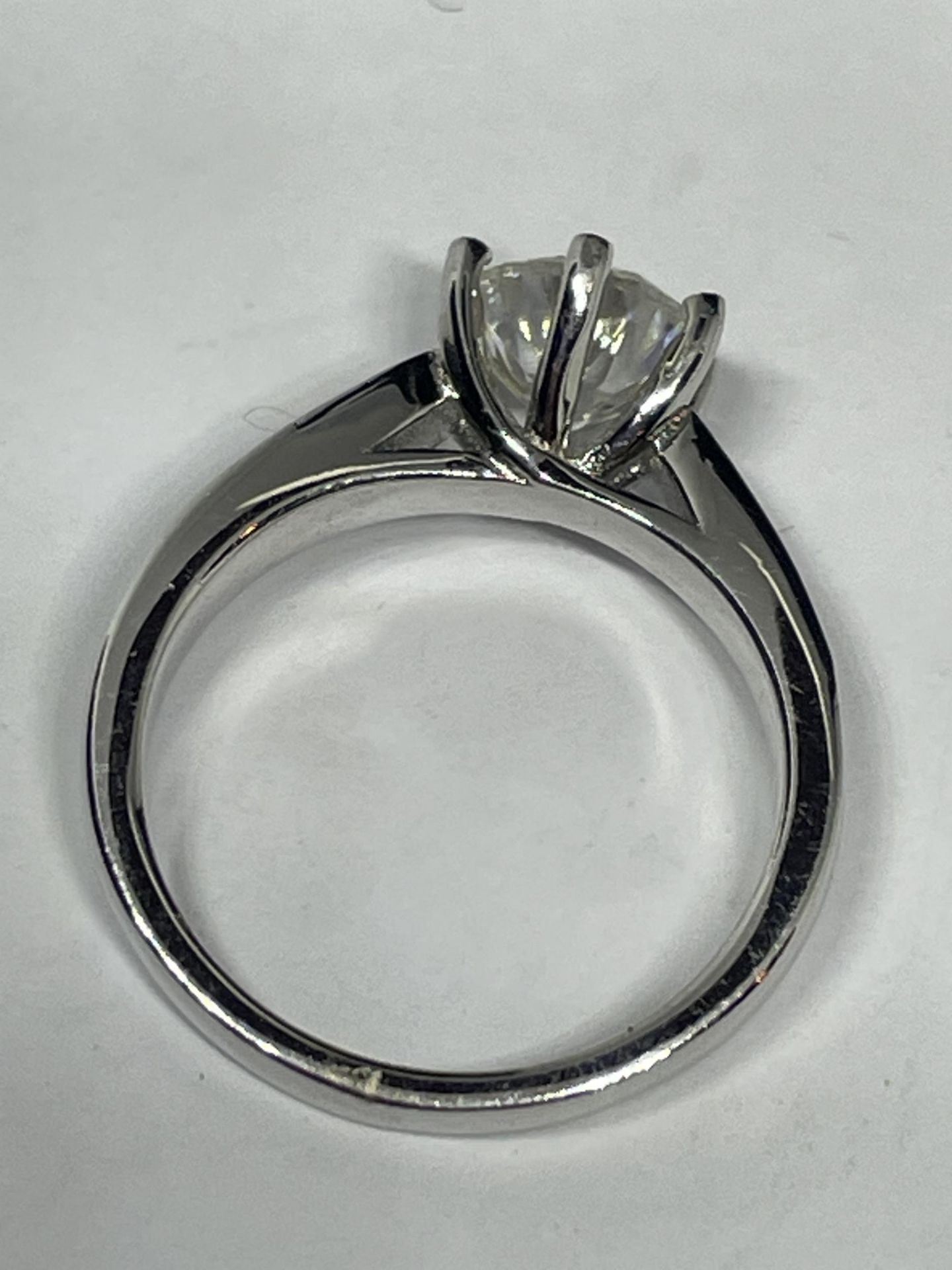A MARKED 9K RING SET WITH A 1 CARAT OF MOISSANITE AS A SOLITAIRE AND CHIPS TO SHOULDERS SIZE I - Image 3 of 4