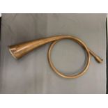 A COPPER, COILED HUNTING HORN