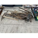 A LARGE ASSORTMENT OF GARDEN TOOLS TO INCLUDE PICK AXES, FORKS AND SPADES ETC