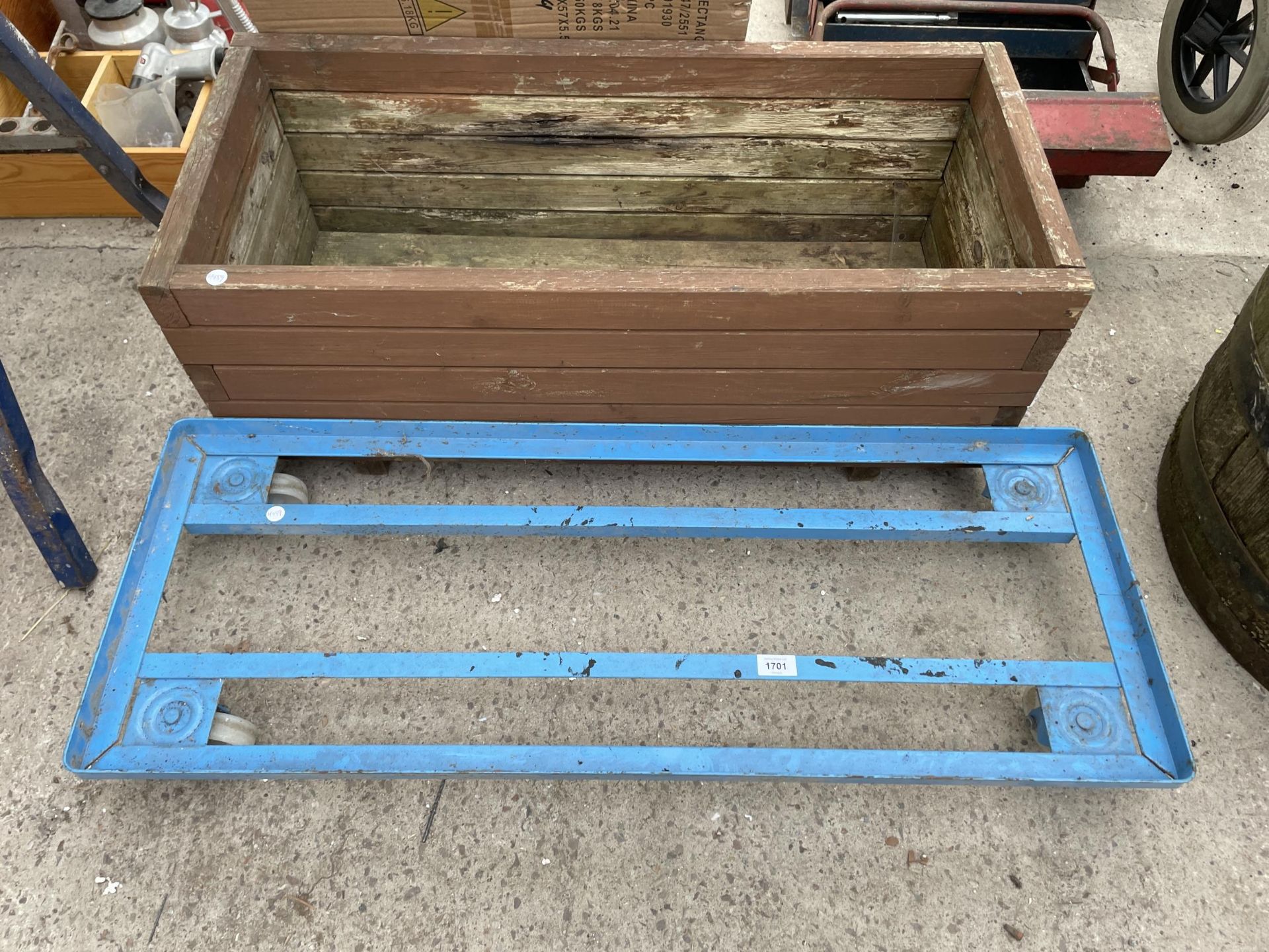 A METAL TROLLEY BASE AND A WOODEN TROUGH PLANTER