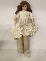 A VINTAGE SAWDUST FILLED DOLL MARKED 3200 M4 DJ TO BASE OF NECK