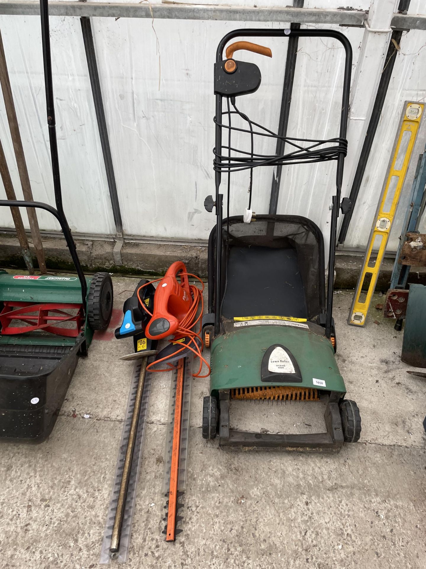 A LAWN RAKE AND TWO ELECTRIC HEDGE TRIMMERS TO INCLUDE A FLYMO ETC