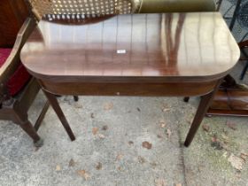 A 19TH CENTURY MAHOGANY FOLD OUT TEA TABLE ON TAPERED AND FLUTED LEGS