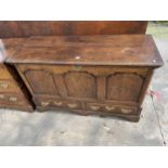 A GEORGE III OAK LANCASHIRE CHEST WITH A THREE PANEL FRONT AND TWO DRAWERS TO BASE ON BRACKET FEET