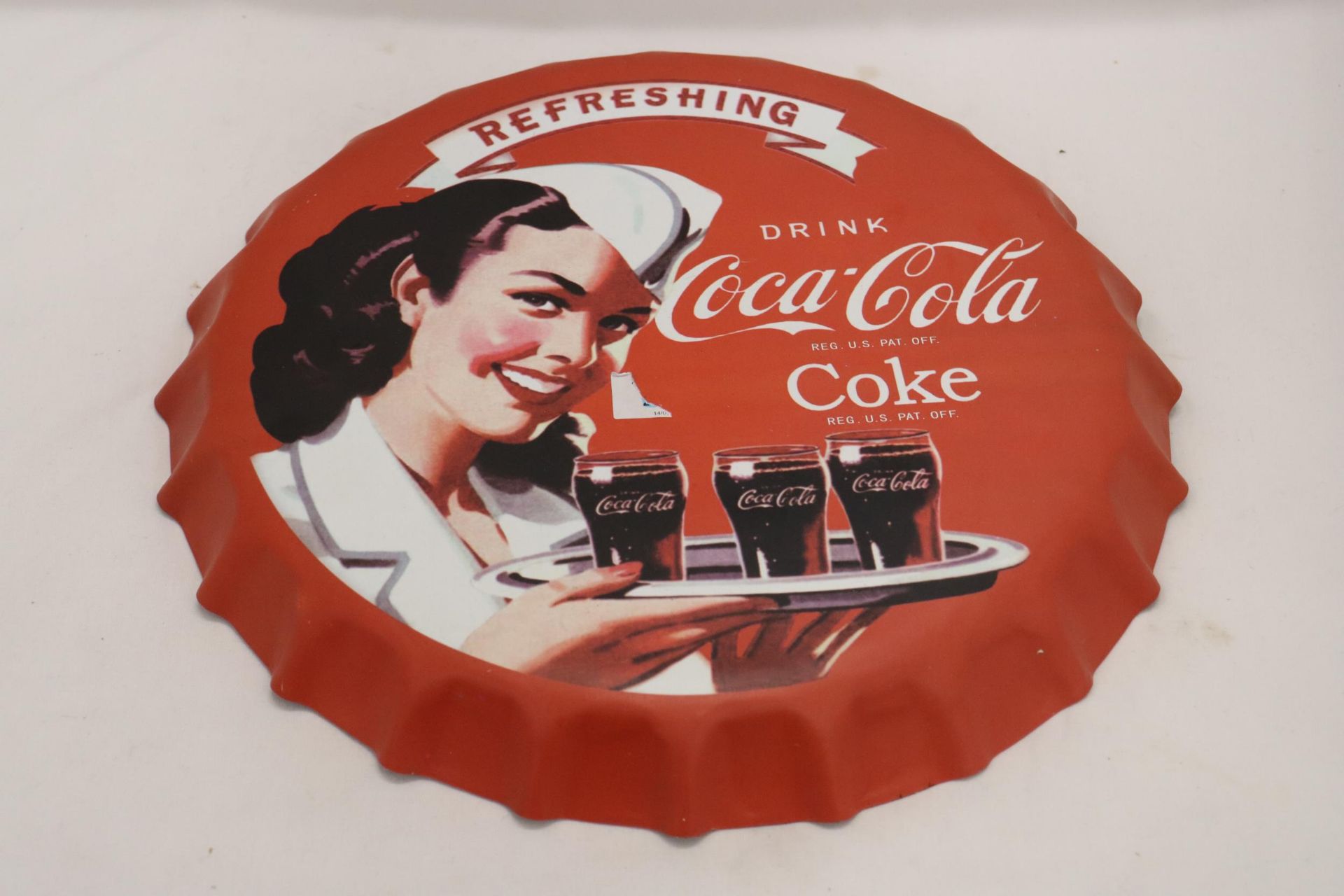 A LARGE COCA-COLA METAL BOTTLE TOP ADVERTISING PLAQUE