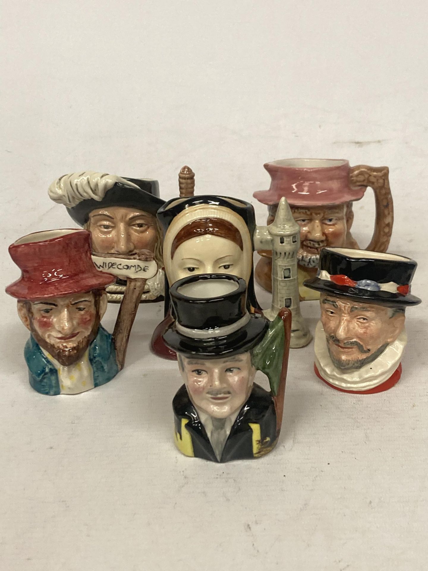 SIX CHARACTER JUGS TO INCLUDE ROYAL DOULTON BEEFEATER, ARAMIS, CATHERINE OF ARAGON, ETC.,