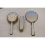 AN ENAMEL AND HALLMARKED LONDON SILVER TWO BRUSH AND MIRROR SET