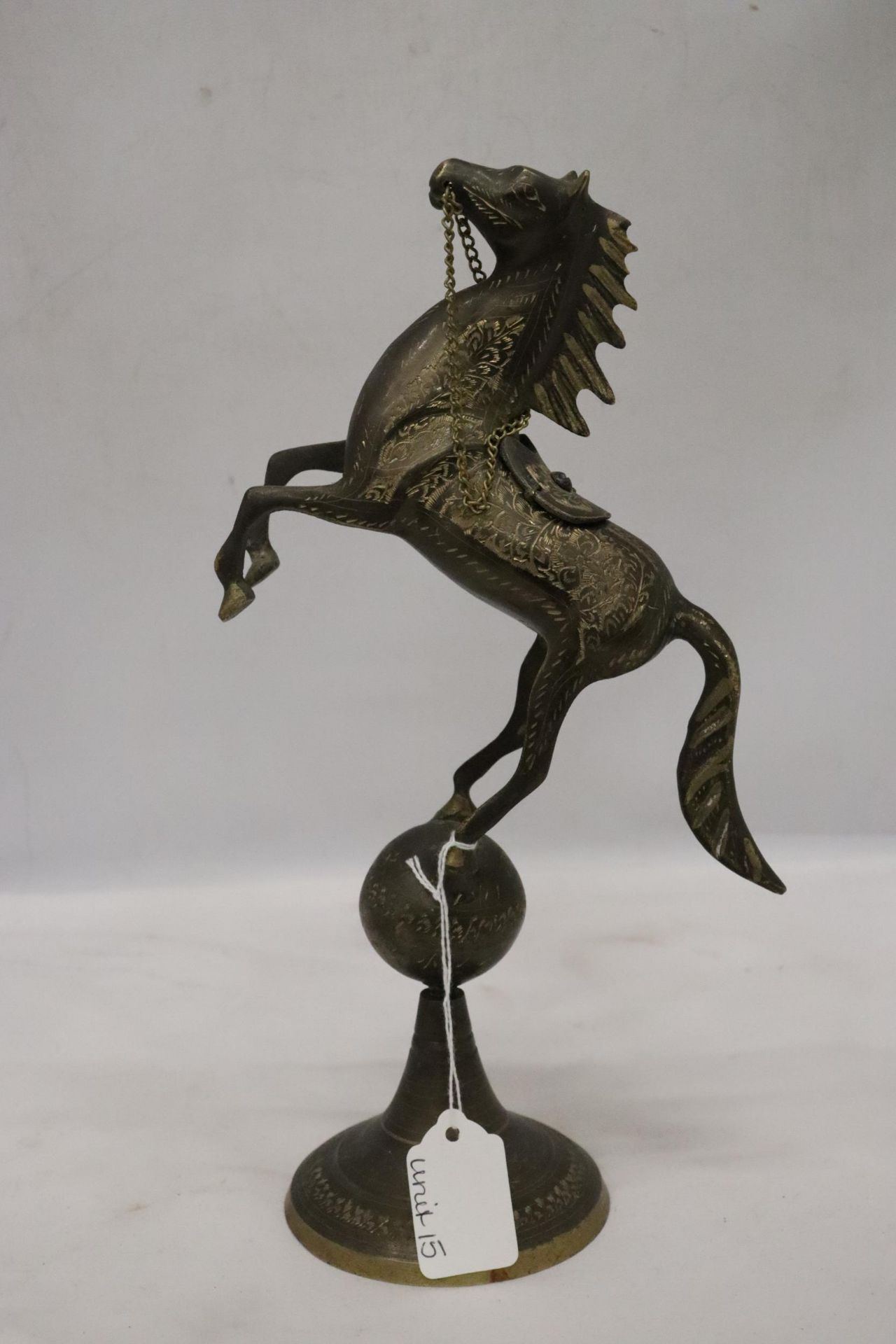 A VINTAGE BRASS ASIAN HORSE