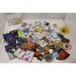 A LARGE COLLECTION OF CLOTH AND PIN BADGES TO INCLUDE GIRL GUIDES, BEAVERS, HOLIDAY DESTINATIONS,