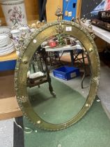 A LARGE BRASS FRAMED ARTS AND CRAFTS OVAL MIRROR