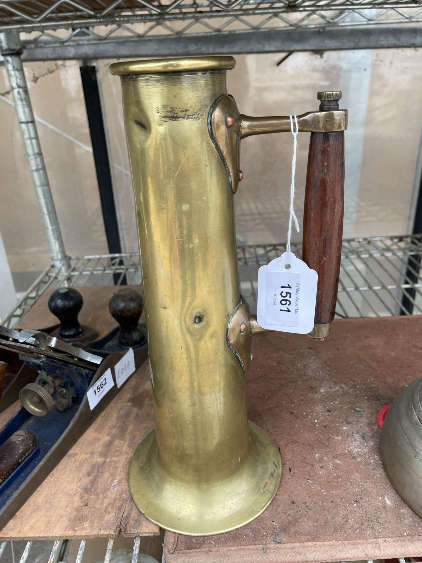 A VINTAGE BRASS STEAM SHIP TEST JUG WITH WOODEN HANDLE