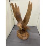 A HAND CARVED WOODEN EAGLE, HEIGHT 37CM