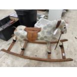 A VINTAGE WOODEN AND FIBRE GLASS CHILDS ROCKING HORSE