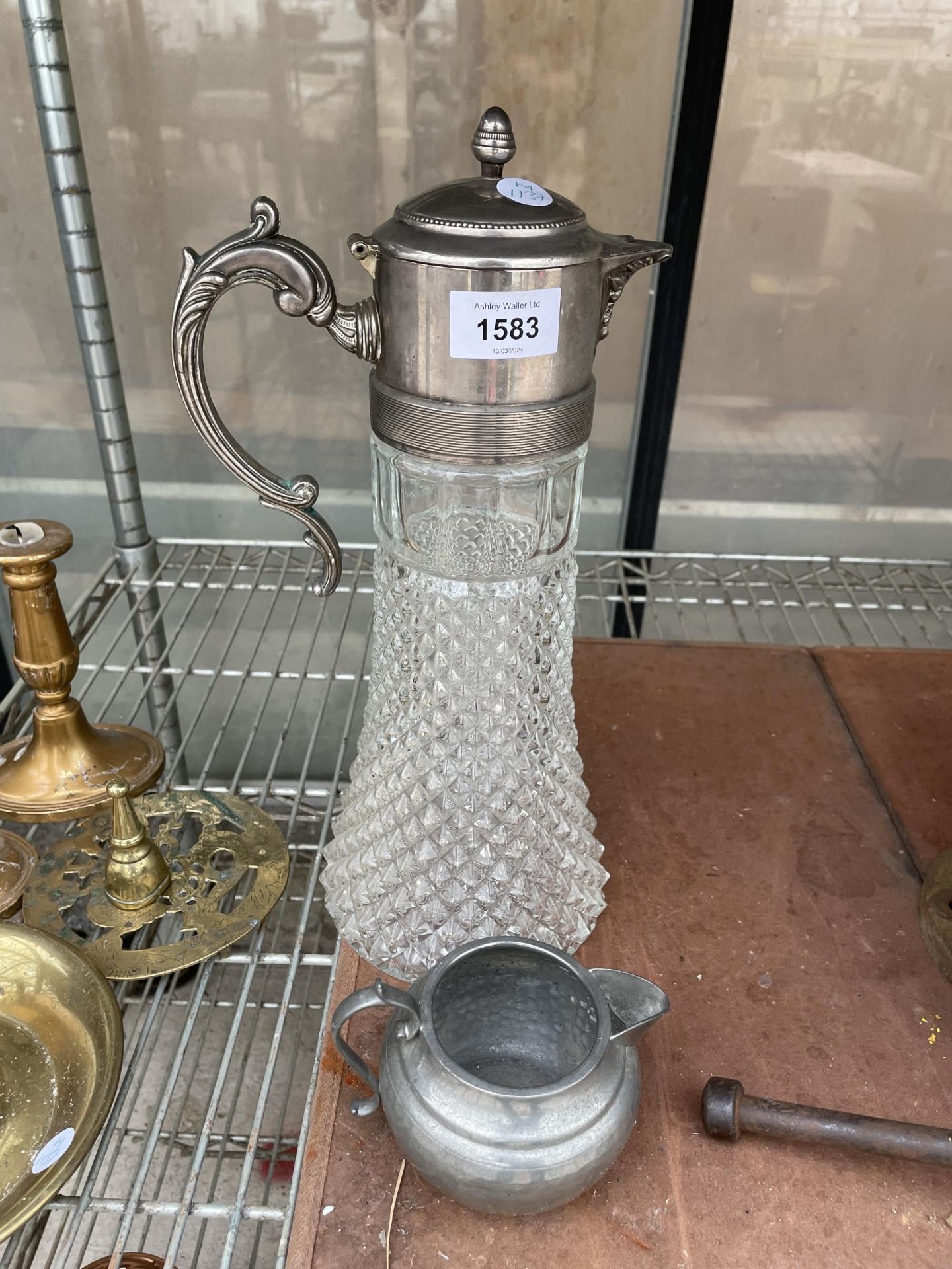 A CUT GLASS CLARET JUG WITH SILVER PLATED TOP AND A SMALL PEWTER JUG