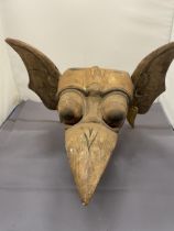 A CARVED WOODEN GARGOYLE MASK