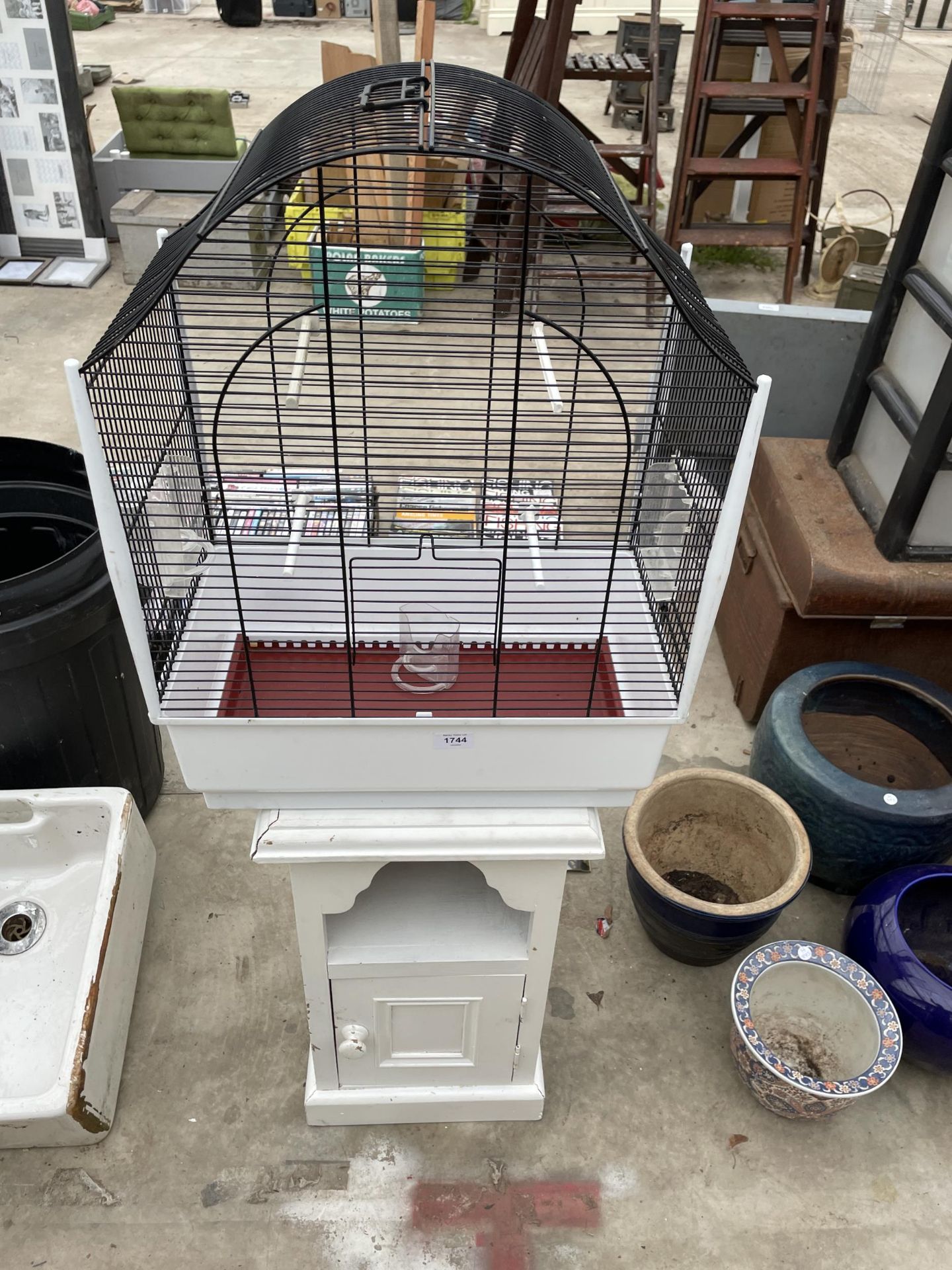 A WOODEN BEDSIDE AND A BUDGIE CAGE