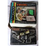 A BINATONE COLOUR TV GAME 4 + 2, BINATONE GAME GUN, TWO CONTROLLERS AND ADAPTER