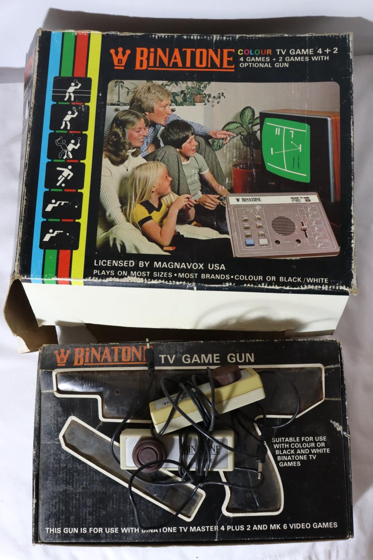 A BINATONE COLOUR TV GAME 4 + 2, BINATONE GAME GUN, TWO CONTROLLERS AND ADAPTER