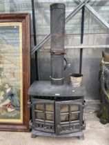 A CAST IRON LOG BURNER WITH FLU PIPE AND BRACKETS