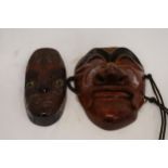 TWO WALL MASKS TO INCLUDE A JAPANESE ONE WITH MARKS TO INNER AND A NEW ZEALAND 'KORURU', 'RURU' IS