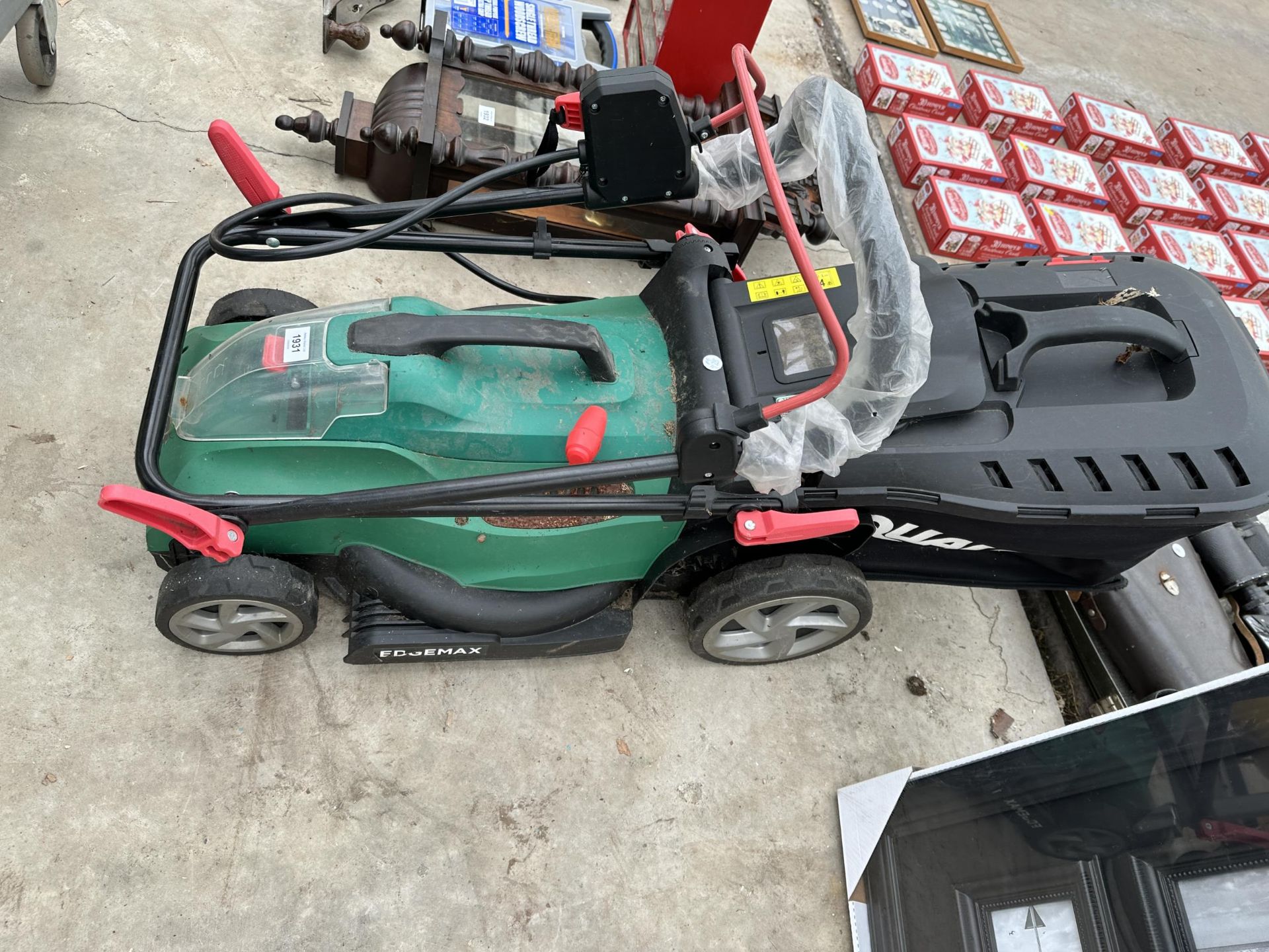 AN ELECTRIC QUALCAST LAWN MOWER WITH GRASS BOX