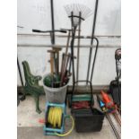 AN ASSORTMENT OF GARDEN TOOLS TO INCLUDE A LAWN MOWER, RAKES AND FORKS ETC