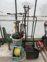 AN ASSORTMENT OF GARDEN TOOLS TO INCLUDE A LAWN MOWER, RAKES AND FORKS ETC