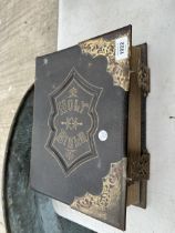 A VINTAGE LEATHER BOUND HOLY BIBLE WITH BRASS DETAIL