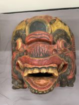 A CARVED, CEREMONIAL STYLE MASK