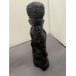 A DARK WOOD, POSSIBLY EBONY, TRIBAL STYLE CARVING, HEIGHT 30CM