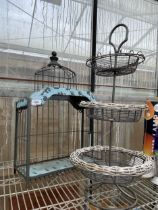 A METAL THREE TIER STAND AND A BIRD CAGE
