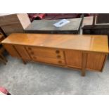 A RETRO TEAK SIDEBOARD ENCLOSING THREE DRAWERS AND FOUR CUPBOARDS BEARING TIMES FURNISHINGS LABEL