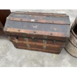 A VICTORIAN COMPRESSED FIBRE DOME TOPPED TRUNK WITH METAL FITTINGS AND WOODEN SLATS 30" WIDE