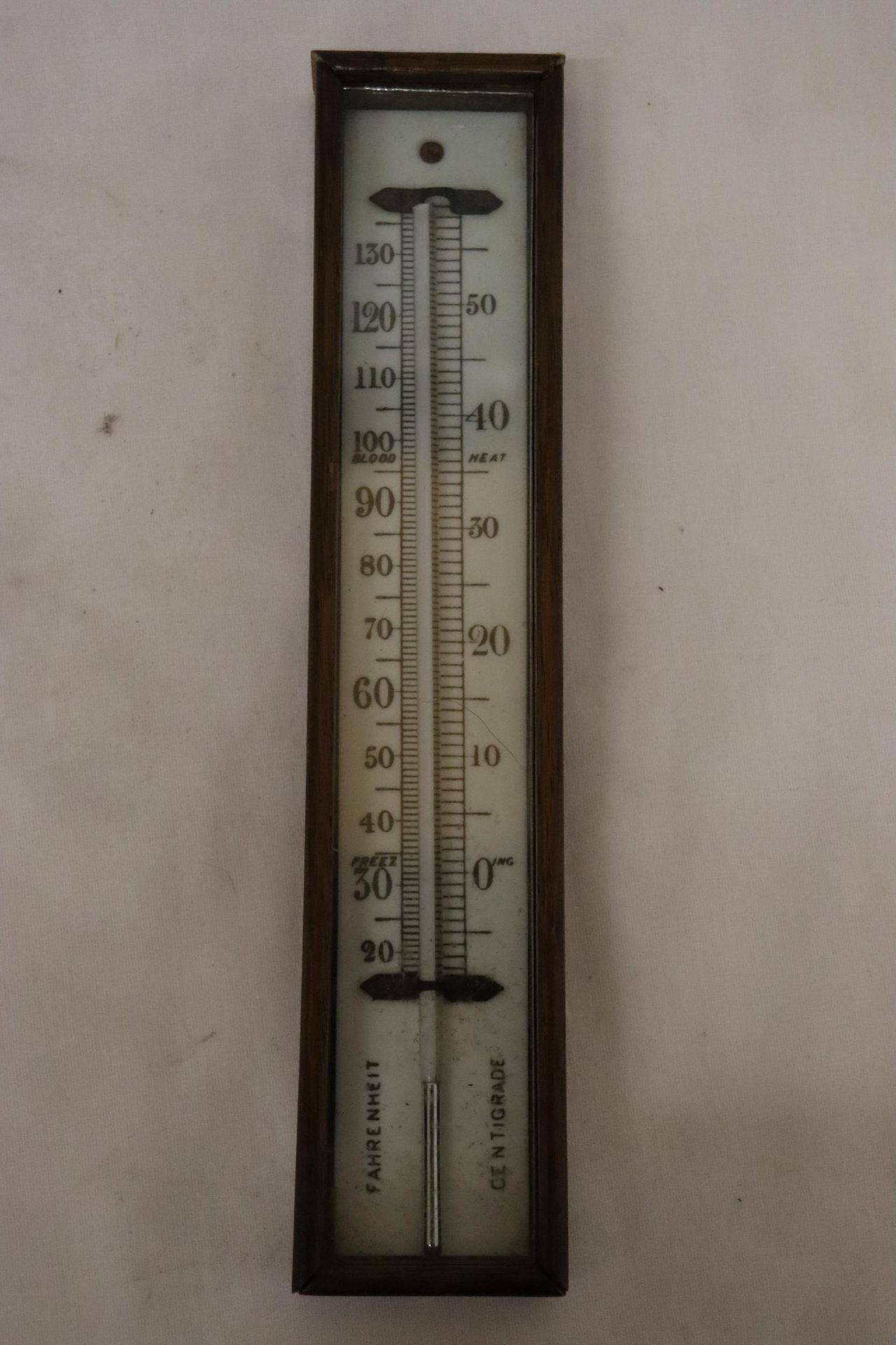 A VINTAGE WALL HANGING THERMOMETER WITH WOODEN CASING