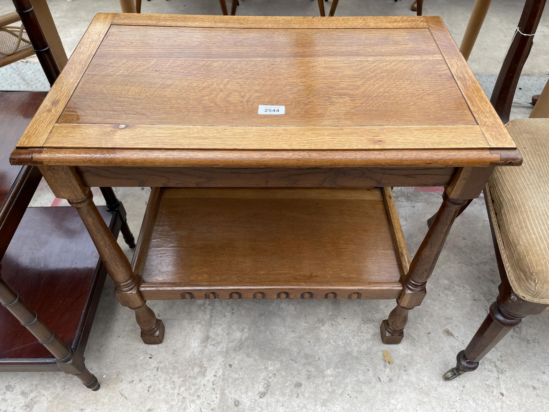 A MID 20TH CENTURY OAK TWO TIER TROLLEY ( LACKING CASTERS)