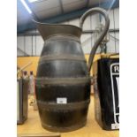 A LARGE OAK AND BRASS BANDED JUG WITH BRASS HANDLE AND TOP HEIGHT 57CM