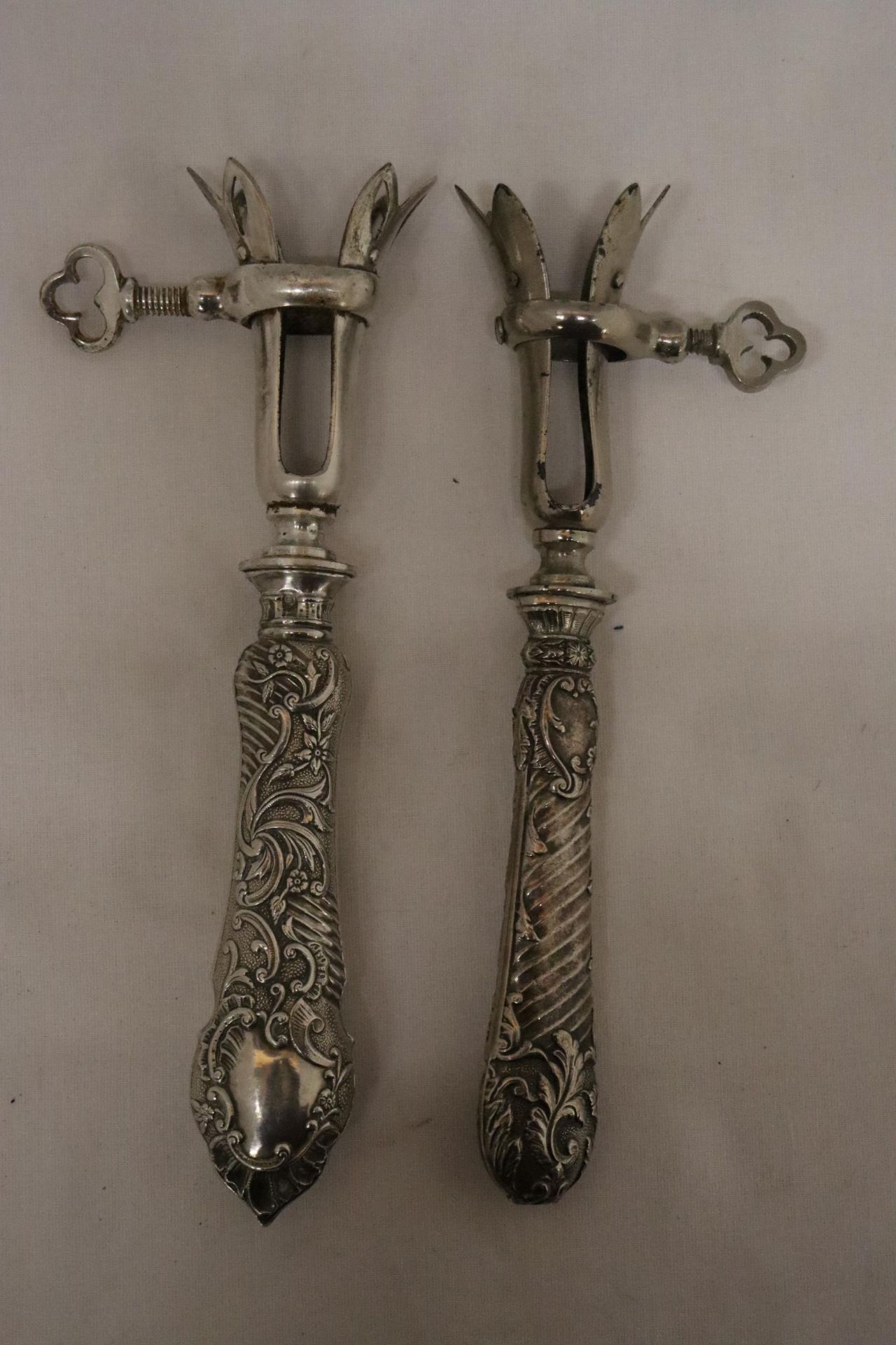 TWO VINTAGE CONTINENTAL, POSSIBLY SILVER, HANDLED GIGOT LAMB SHANK/HAM BONE HOLDERS