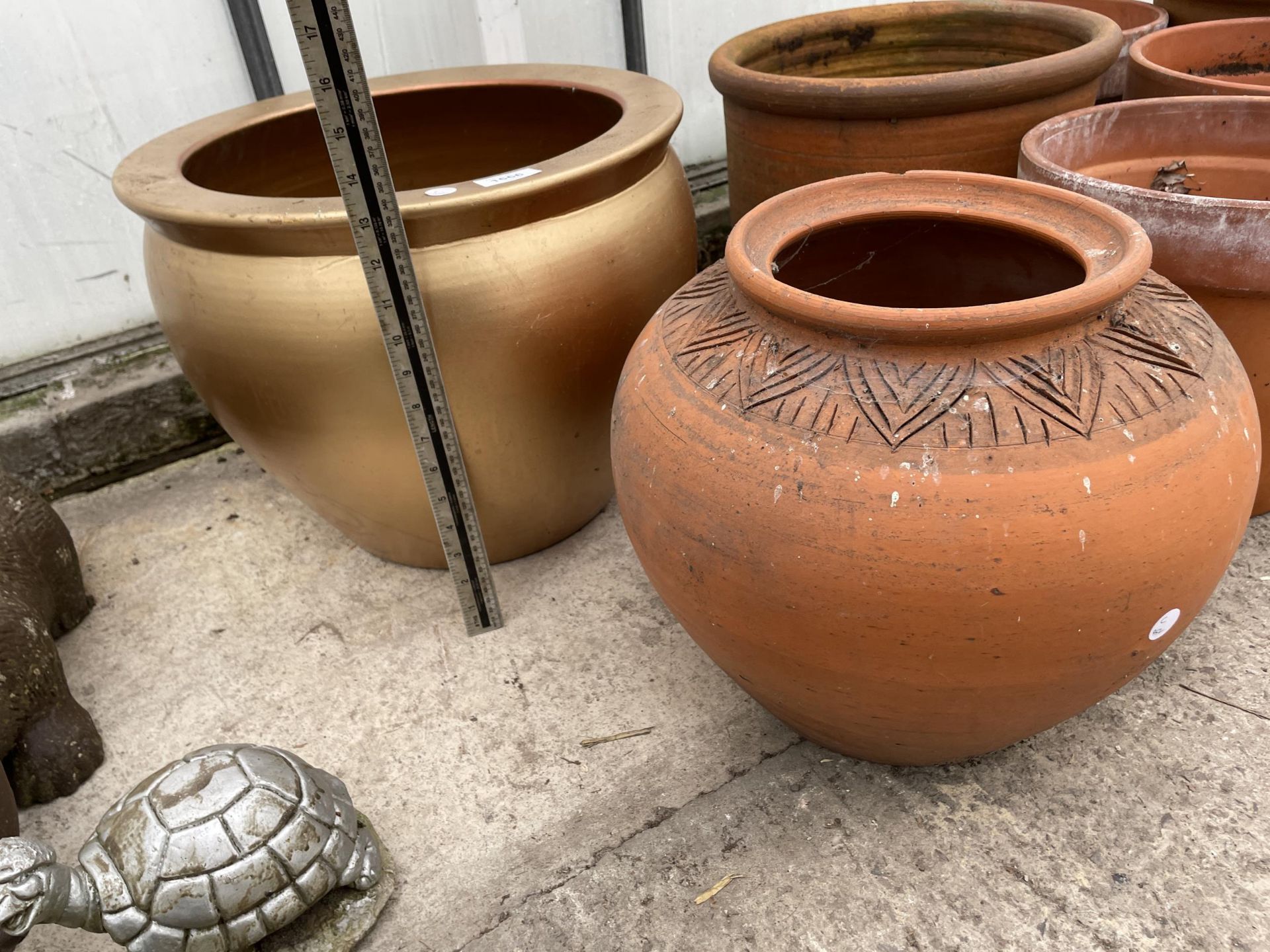 A TERRACOTTA PLANTER AND A FURTHER GILT TERRACOTTA PLANTER