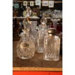 FOUR CUT GLASS DECANTERS ONE WITH A WHISKEY DECANTER LABEL
