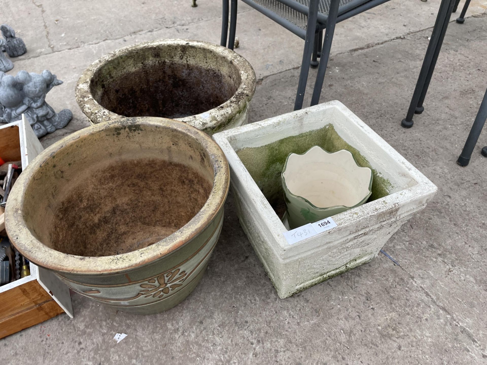 AN ASSORTMENT OF CONCRETE AND CERAMIC PLANTERS