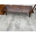 A RETRO COFFEE TABLE ON KICK OUT LEGS